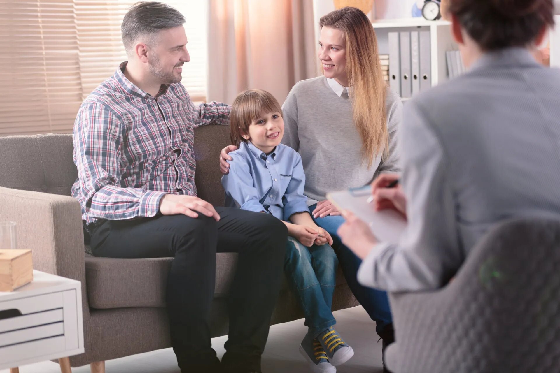 Photo of parents and child with therapist